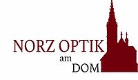 Das Bild zeigt den Rottenburger Dom in dunkelrot und den Schriftzug Norz Optik am Dom.